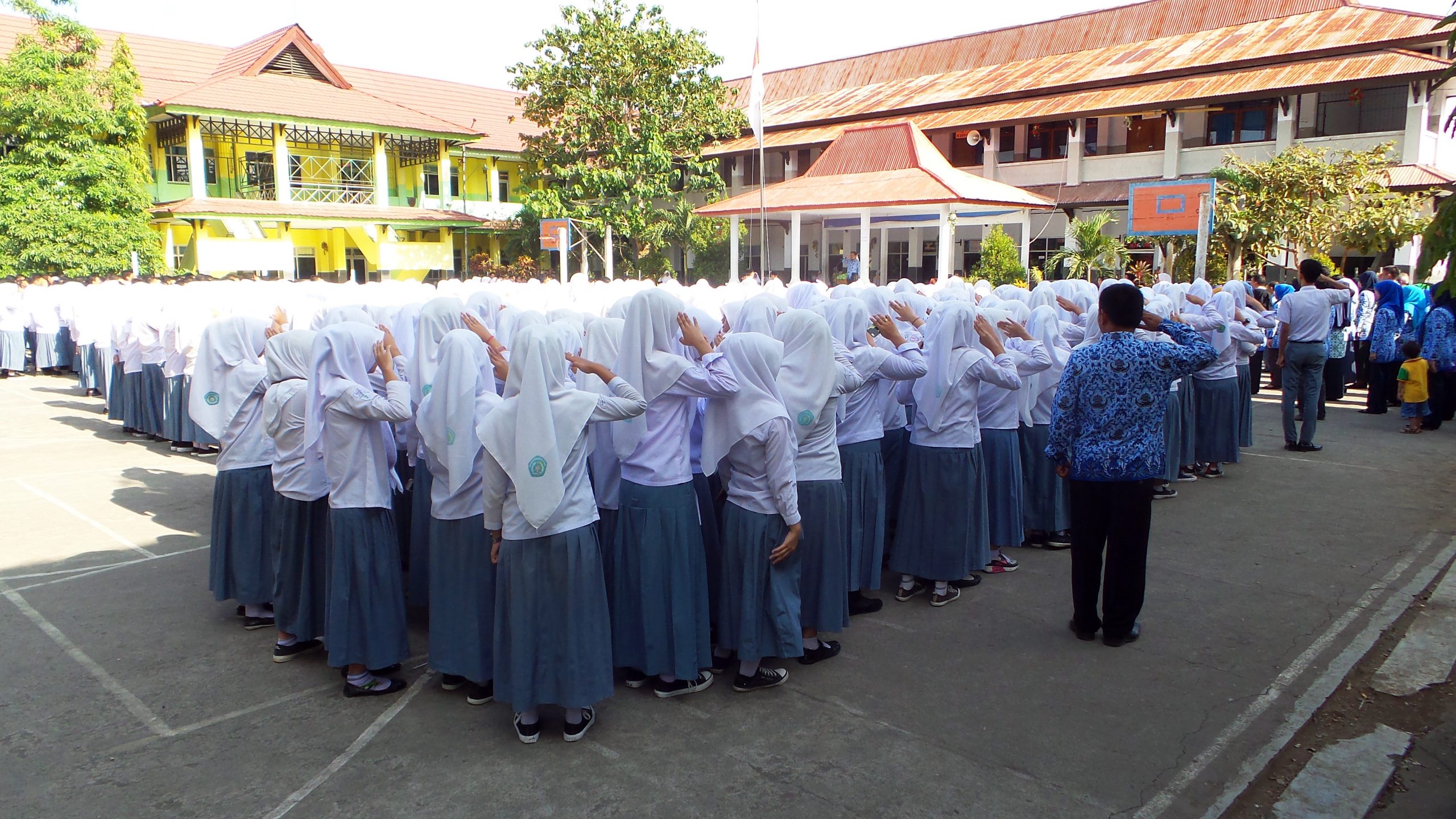 Students salute the flag during a ceremony at the public madrasah. Photo courtesy of the author

