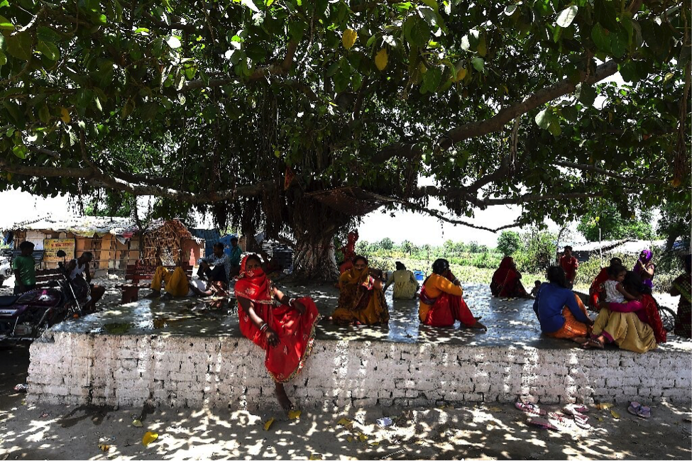 Figure 1. Some Delhi residents escaping from the heat under the shade of a tree. Photograph by Aishwarya Kumar. (May 27, 2020). Retrieved from https://phys.org/news/2020-05-india-wilts-heatwave-temperature-degrees.html