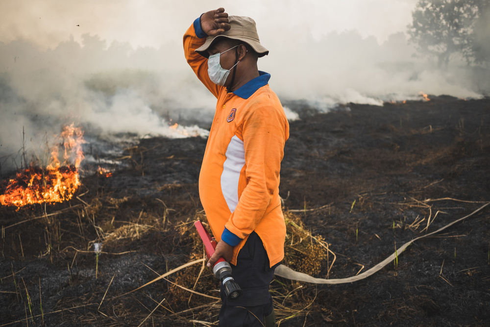 Indonesian firefighters try to extinguish peatland at Rumbai Pesisir Village in Pekanbaru, Riau Province, Indonesia, on Feb. 26, 2020.