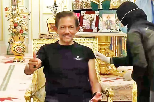 A screen grab from Radio Television Brunei shows His Majesty Sultan Haji Hassanal Bolkiah, Sultan and Yang Di-Pertuan of Brunei Darussalam giving a thumbs up after receiving the Covid-19 vaccine. © Borneo Bulletin/ANN