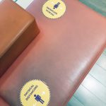 Physical distancing signs on seats in a bank.
