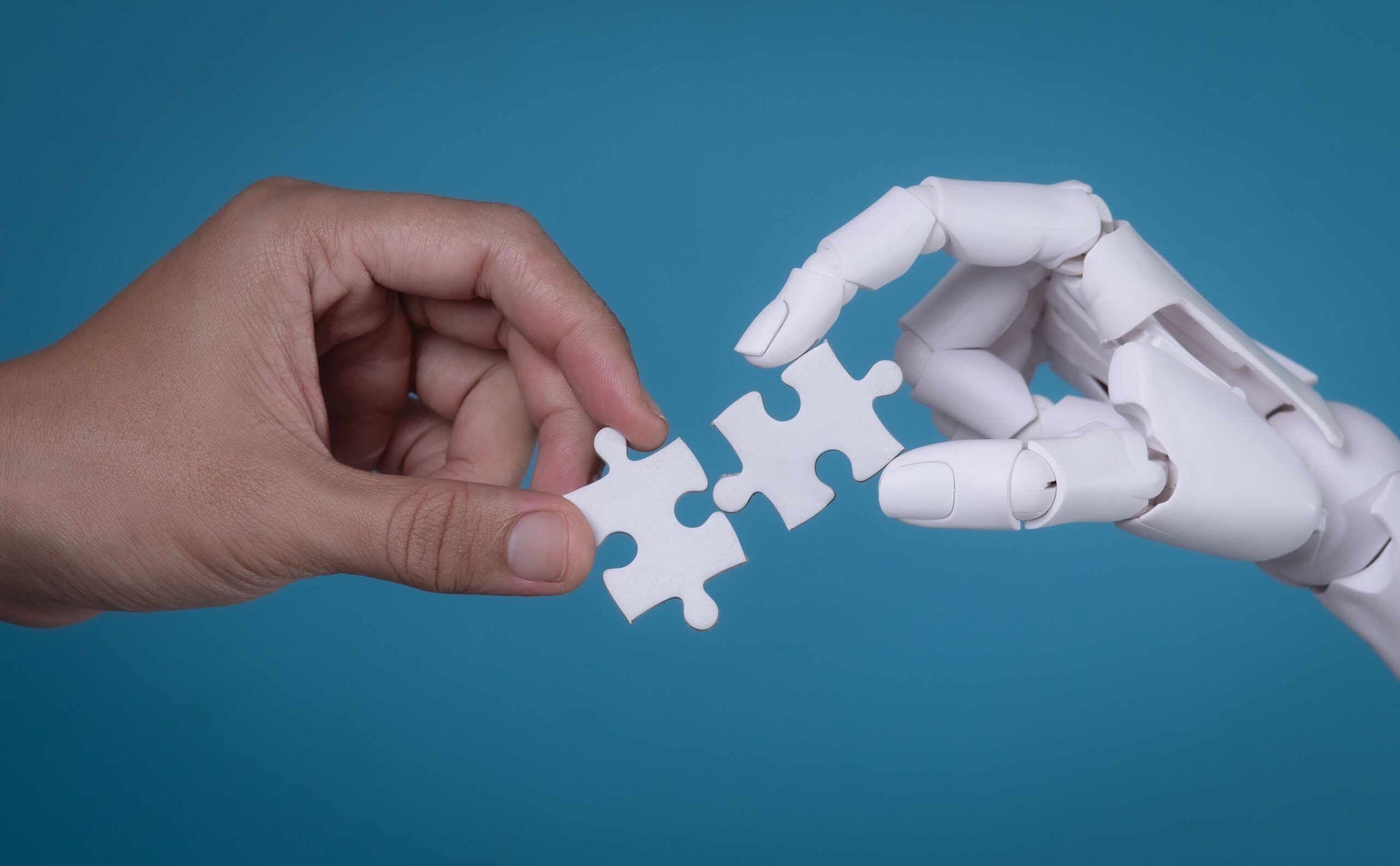 Human,And,Robot,Hands,Connecting,Two,Puzzle,Pieces:,Ai,And